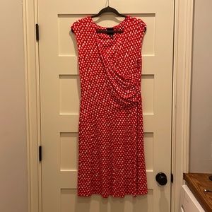 Sleevesless, V-neck, faux wrap with side ruching. Very figure flattering.